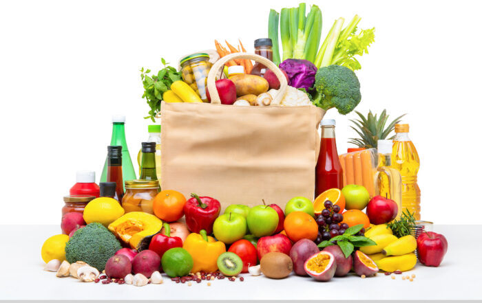 shopping bag full of fresh fruits and vegetables with assorted ingredients